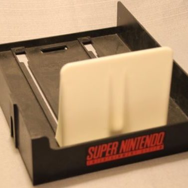 SNES game holder in black with red Super Nintendo logo